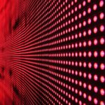 Vibrant abstract pattern of illuminated red LED lights forming a dynamic design.